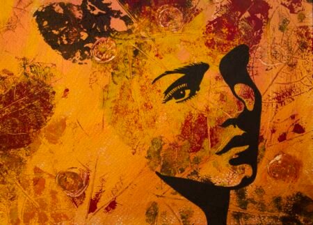 Art piece with orange golden red background, maroon leaves and part of a womans face.